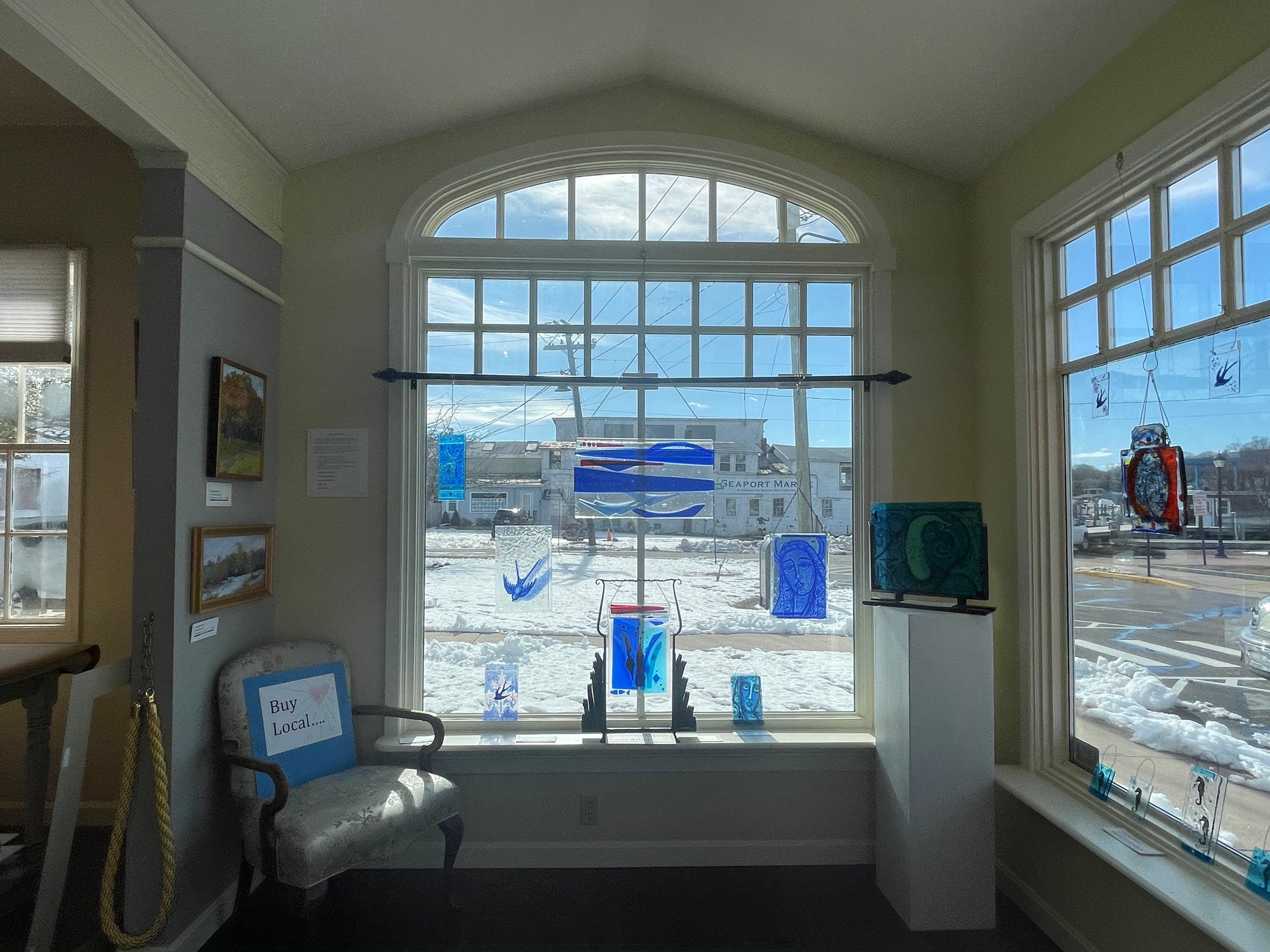 View of right inside front gallery window with fused glass pieces of Catherine Gibson
